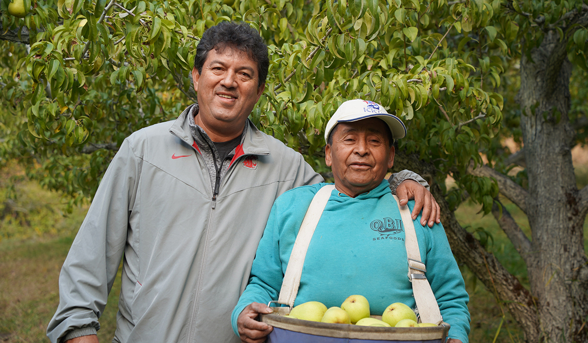 Francisco with Apolinar Ramos in apple orchard.