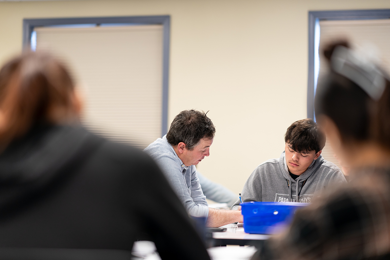 Teacher helping student in class