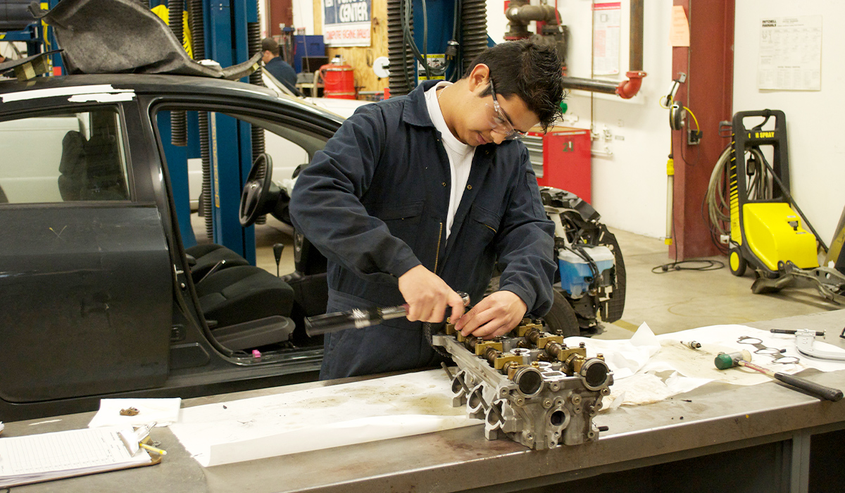 A WVC student works on a car engine in the auto shop.