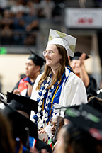 Nursing graduate Mary Smith stands during the graduation ceremony to be recognized as a President's Medal nominee.