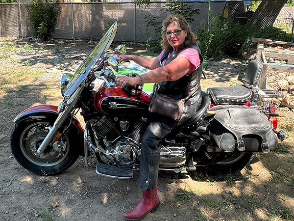 Barbara Oldham sits on her motorcycle.