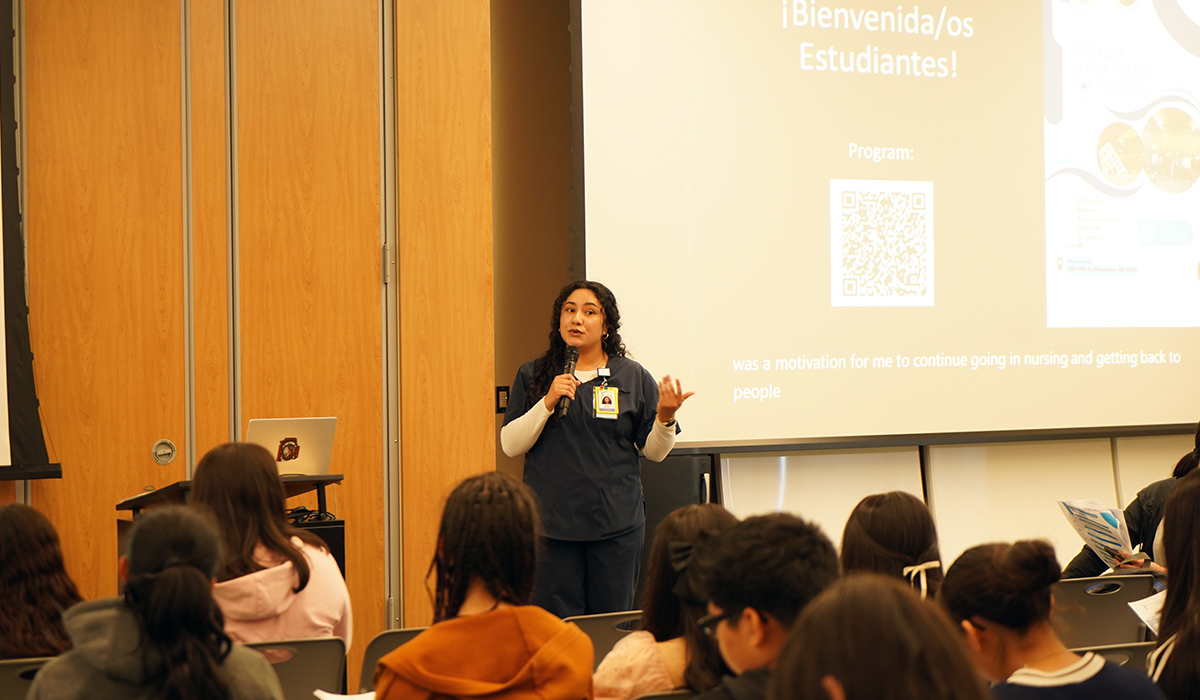 A nurse speaks to a group of CAMP students.